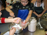 Amy using purple rewana to bake the green bread