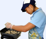 Student cooking chicken for her project