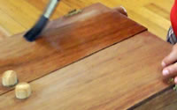 Maraika varnishing her jewellery cabinet