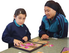 Khrimsen Arnold Comer and Chulan with her
finished Frangipani flower puzzle.