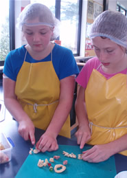 Some of Jacquey's students cutting dehydrated apples and fruits for the nuggets mixture