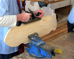 Student shaping the cut board 