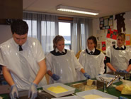 Students crumbing fish
