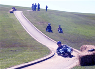A student riding his luge down the track