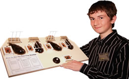 Logan holding his stoat trap display